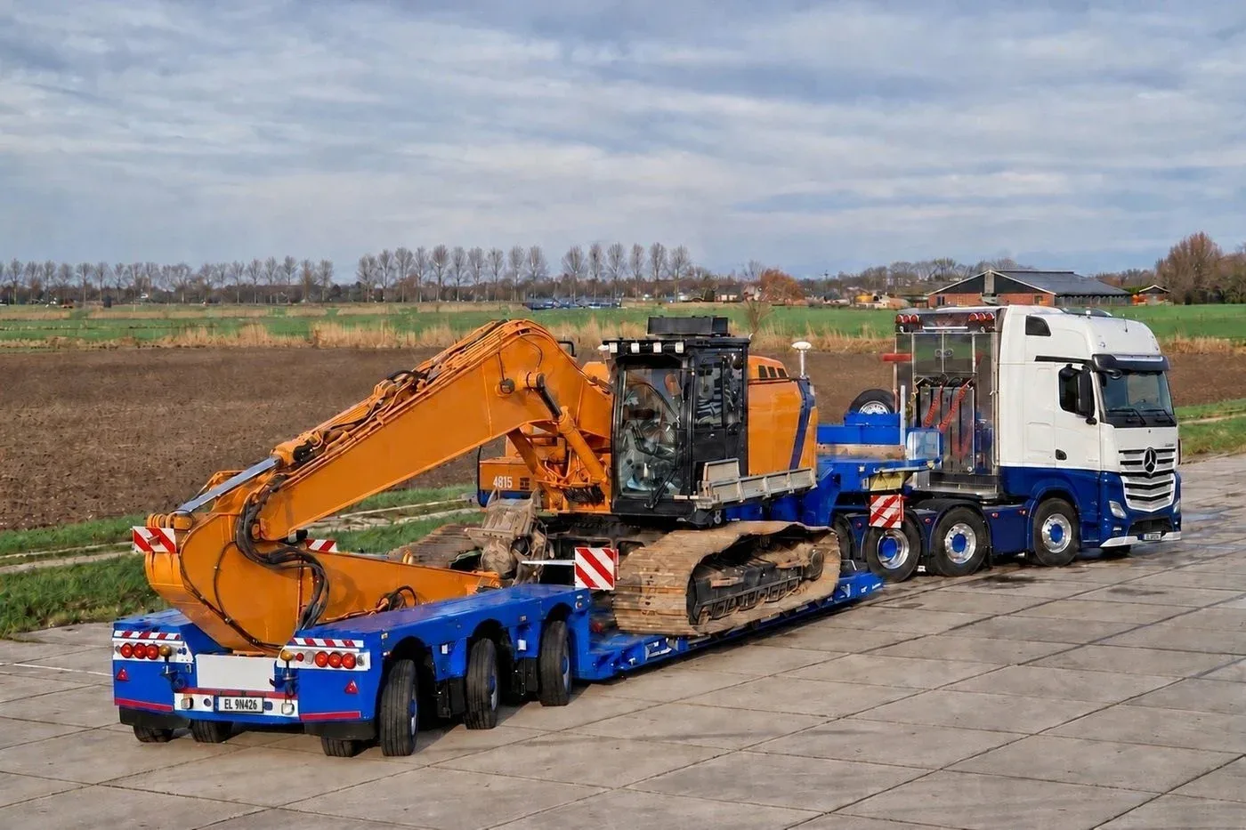 Koparka gąsienicowa na naczepie niskopodwoziowej, ciągnik Mercedes – transport Gabaryty.net